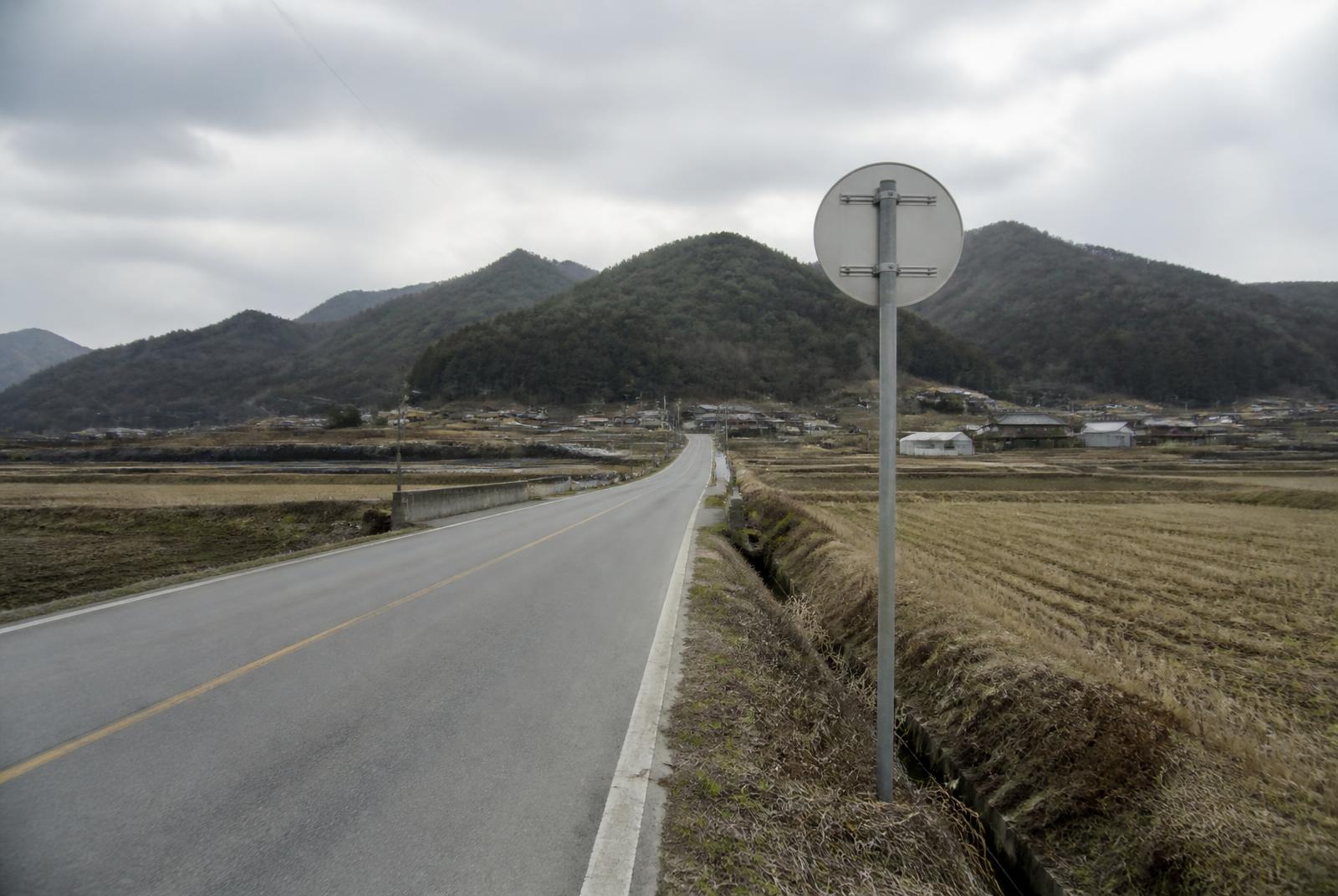 A rural road running past fields toward low hills near Jeonui-myeon